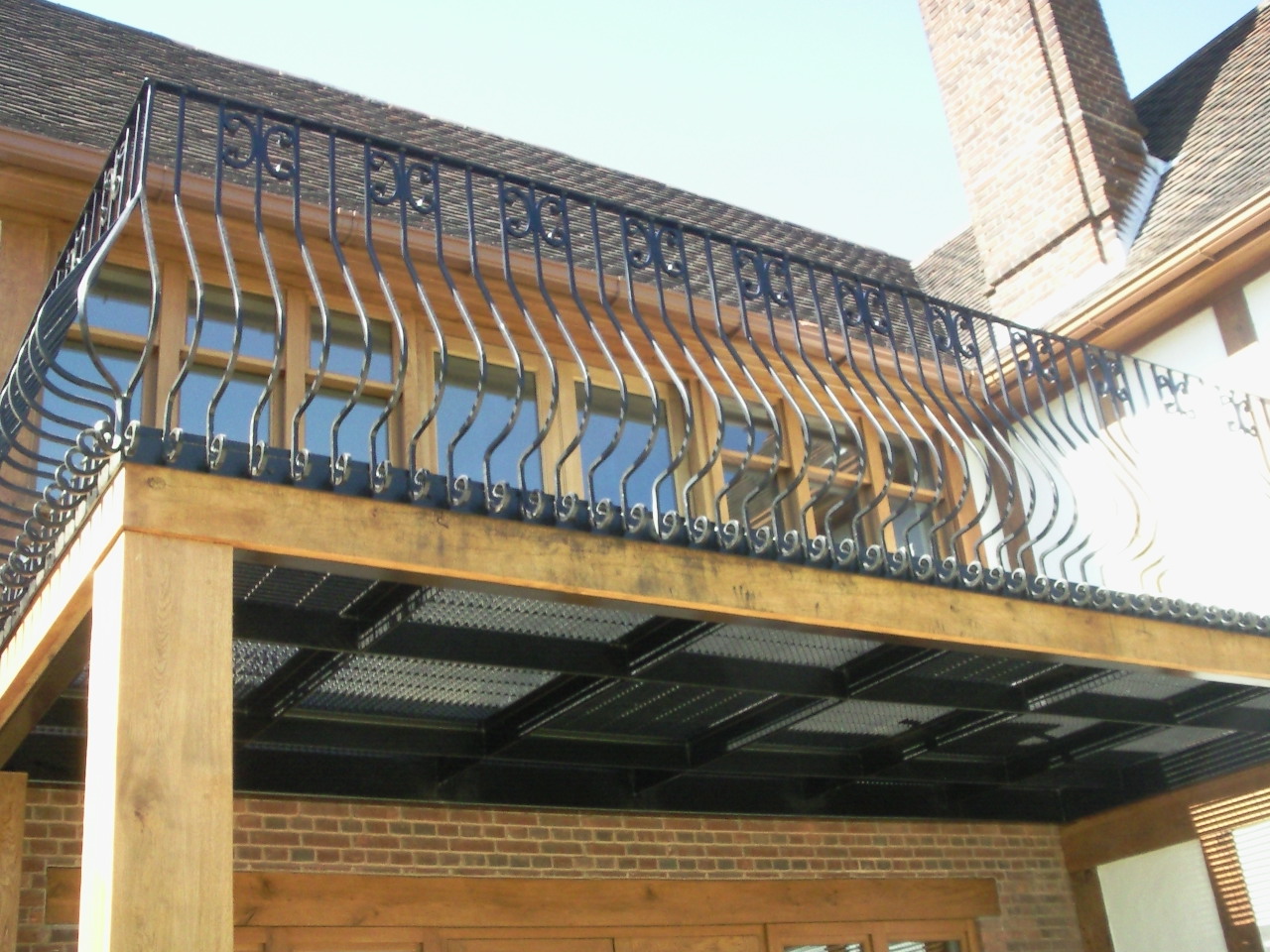 wrought iron balcony, iron balcony with wood, wooden staircase